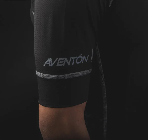 A man wearing a black shirt with the AVENTON HIGHSNOBIETY JERSEY on it, showcasing e-bikes accessories.