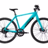 A turquoise Soltera 2.5 Ebike with black wheels, disc brakes, flat handlebars, and a sleek frame is shown in side profile against a white background.