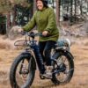 A woman riding the AVENTURE.2 Step Through Ebike in the woods in WA.