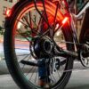 A person is riding a LEVEL.2 Commuter Ebike at night in the USA.