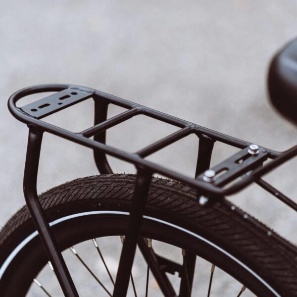 A close up of a bicycle with the AVENTON REAR RACK - PACE 350 / PACE 500 on it, showcasing ebikes accessories.