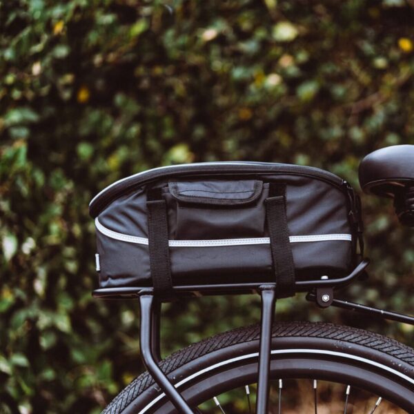 A black bicycle with an AVENTON REAR RACK - PACE 350 / PACE 500 on the back, perfect for USA riders in need of Ebikes and e-bikes accessories.