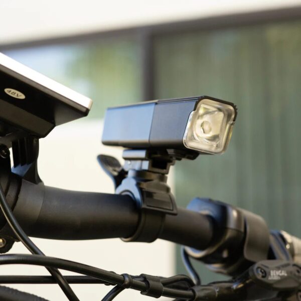 A AVENTON HEAD LIGHT V10-500 attached to the handlebar of a bike, perfect for ebikes and e-bikes accessories.