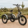 An Electric XP Trike parked in the desert with cactus in the background, surrounded by ebikes and e-bikes accessories.