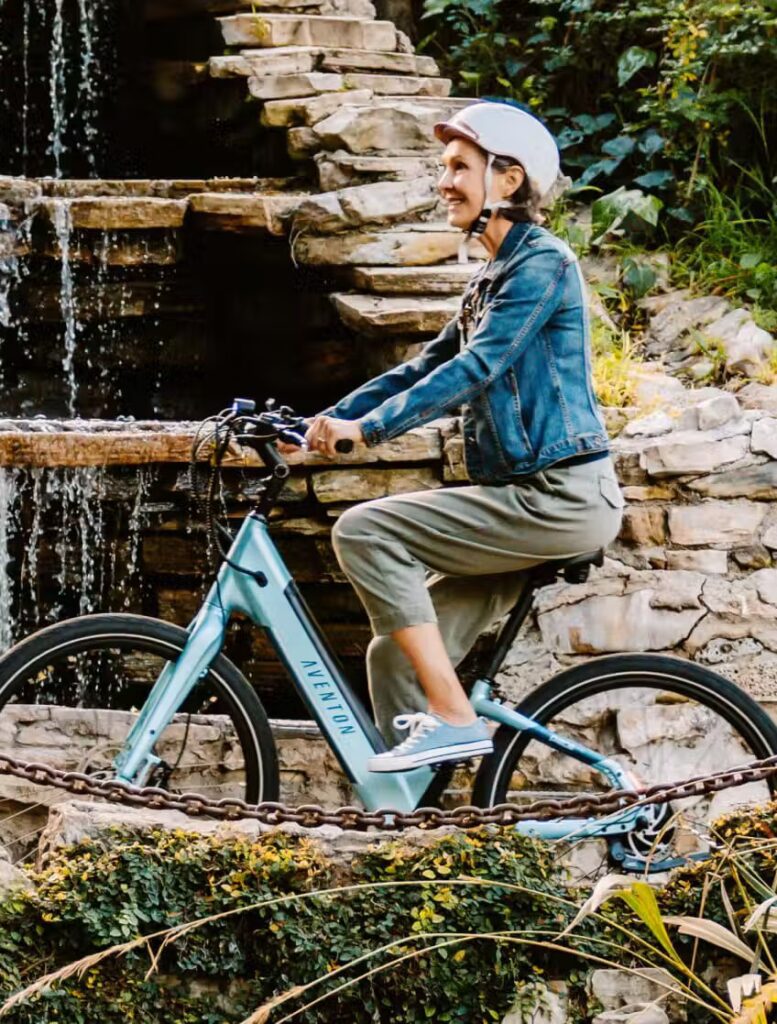 A woman riding an electric bike near a waterfall in the USA.