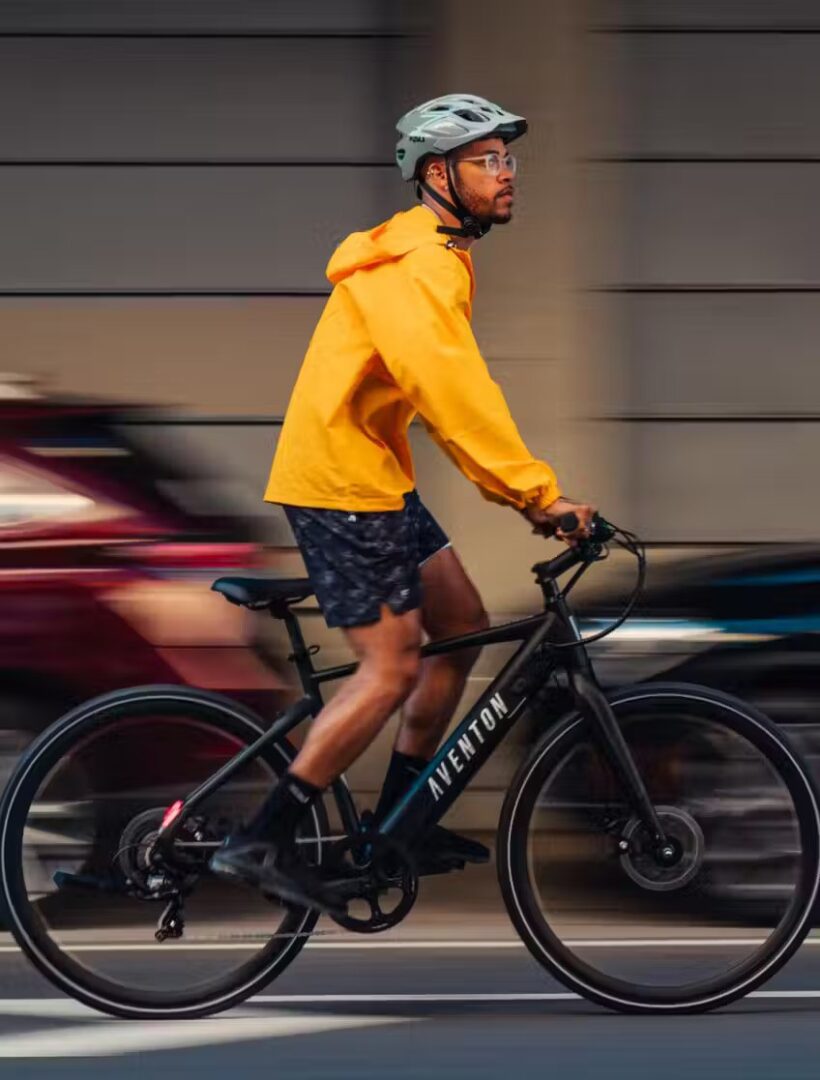 A man riding an electric bike on a city street, showcasing the convenience and efficiency of ebikes in WA, USA.