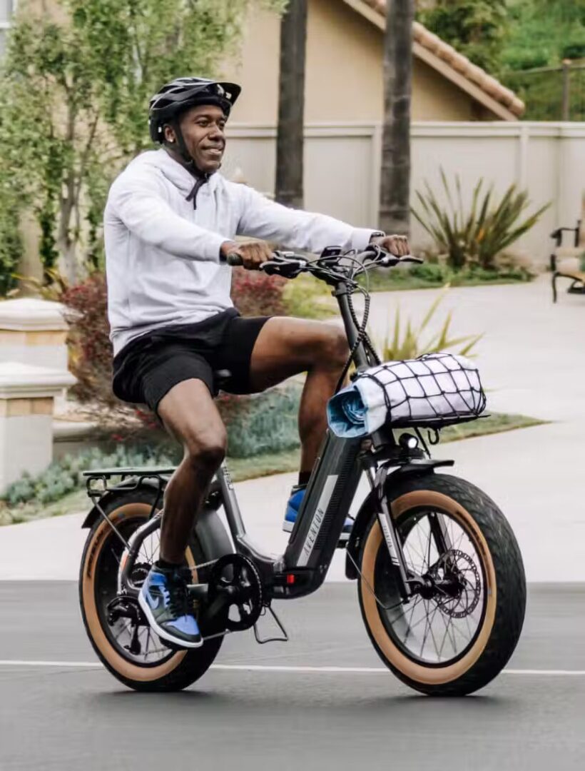 A man riding an electric bike in a residential area, showcasing the latest e-bike accessories.