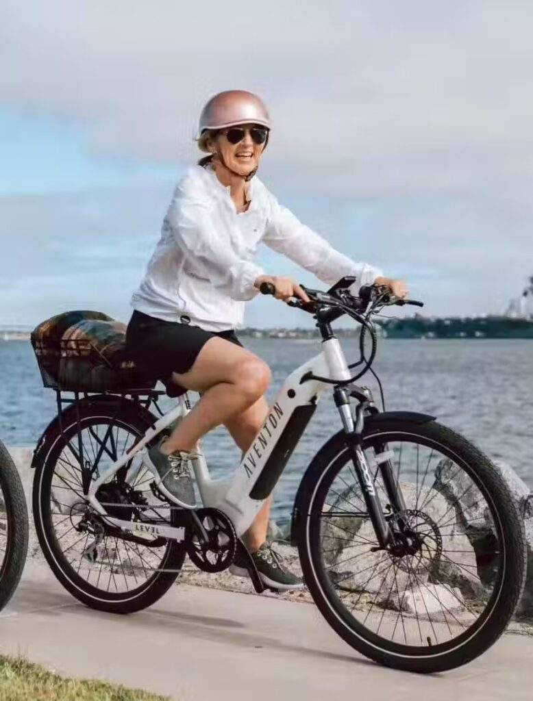 Two women riding ebikes next to a body of water in WA, USA.