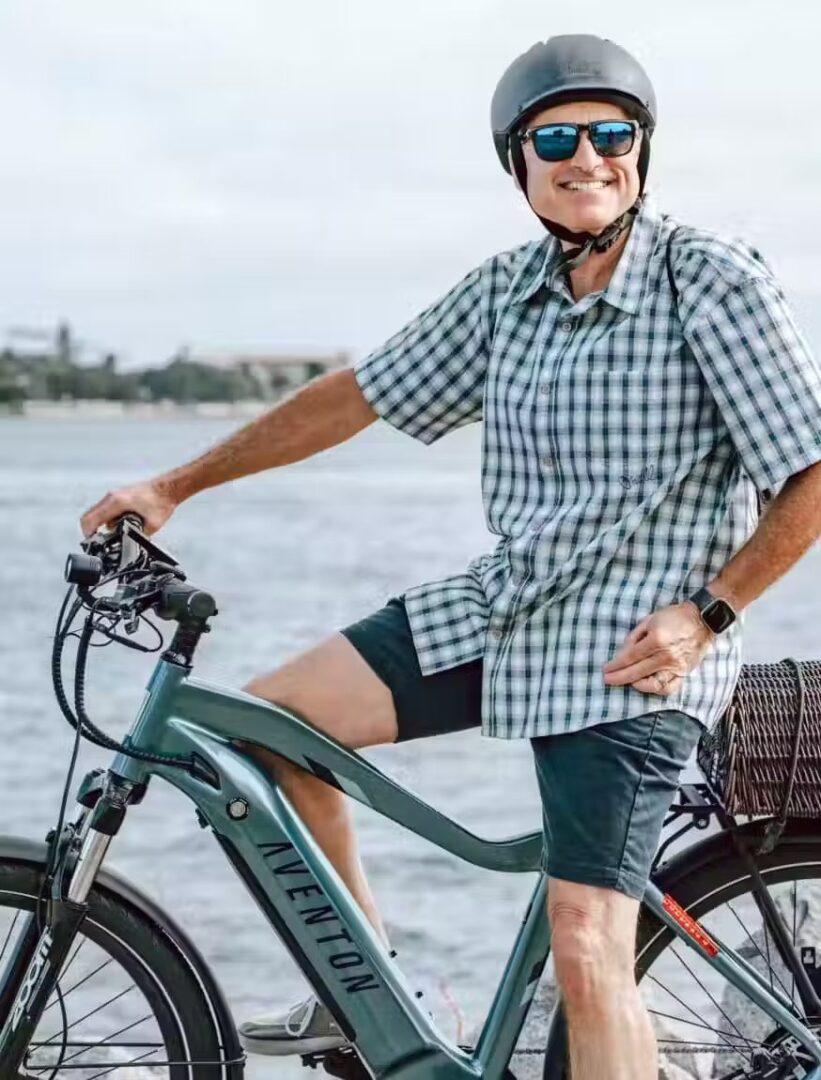 An older man on an electric bike next to the water in WA, USA.