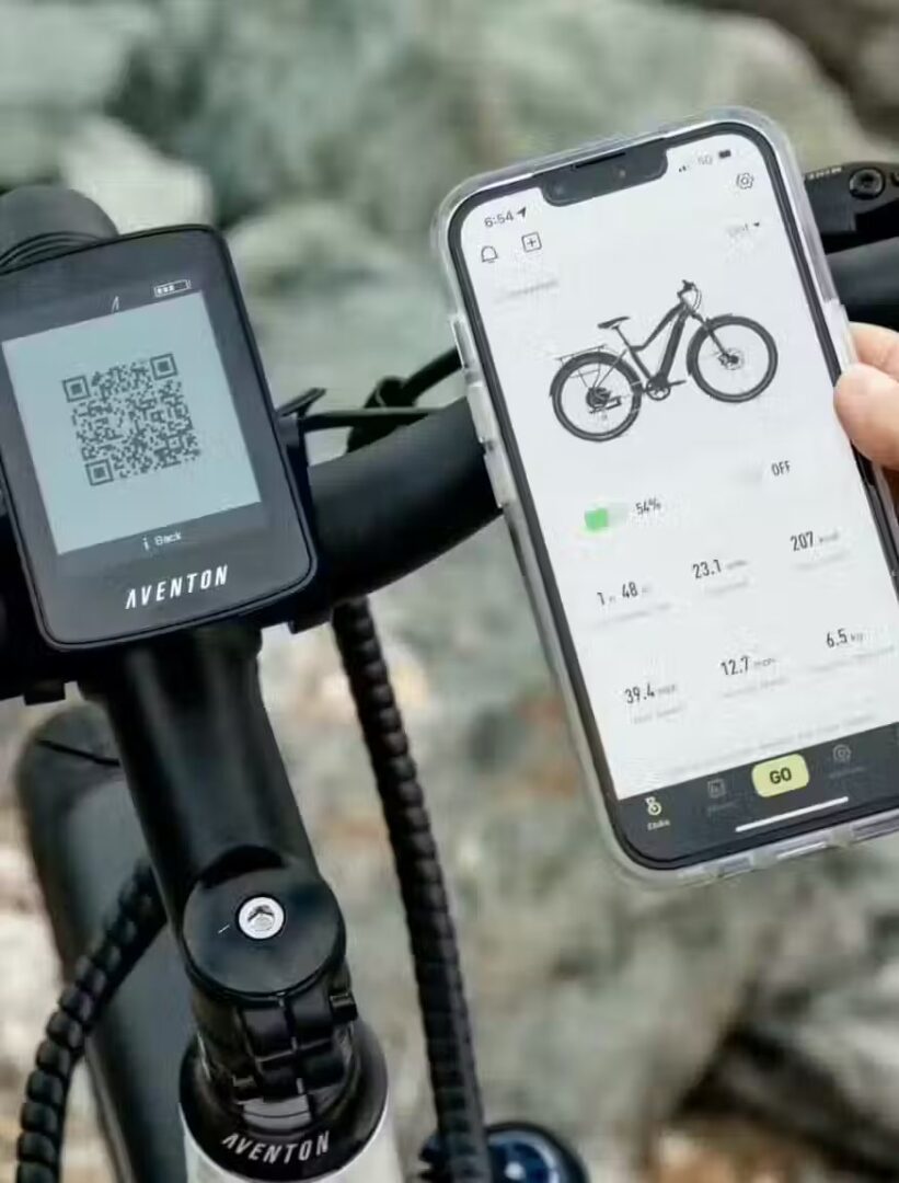 A person holding a smart phone next to a bicycle and browsing for ebike accessories.