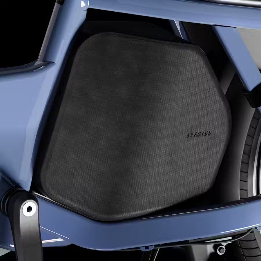 The back seat of a blue motorcycle with a seat cover and e-bikes accessories.