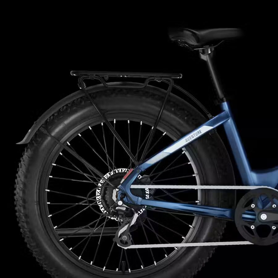 A blue fat bike, perfect for exploring rugged USA terrain, is shown against a black background.