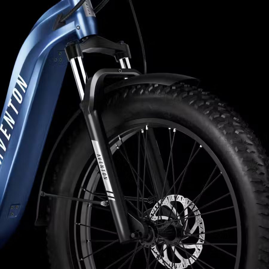 A close up of a blue electric bike on a black background. Keywords: Ebikes