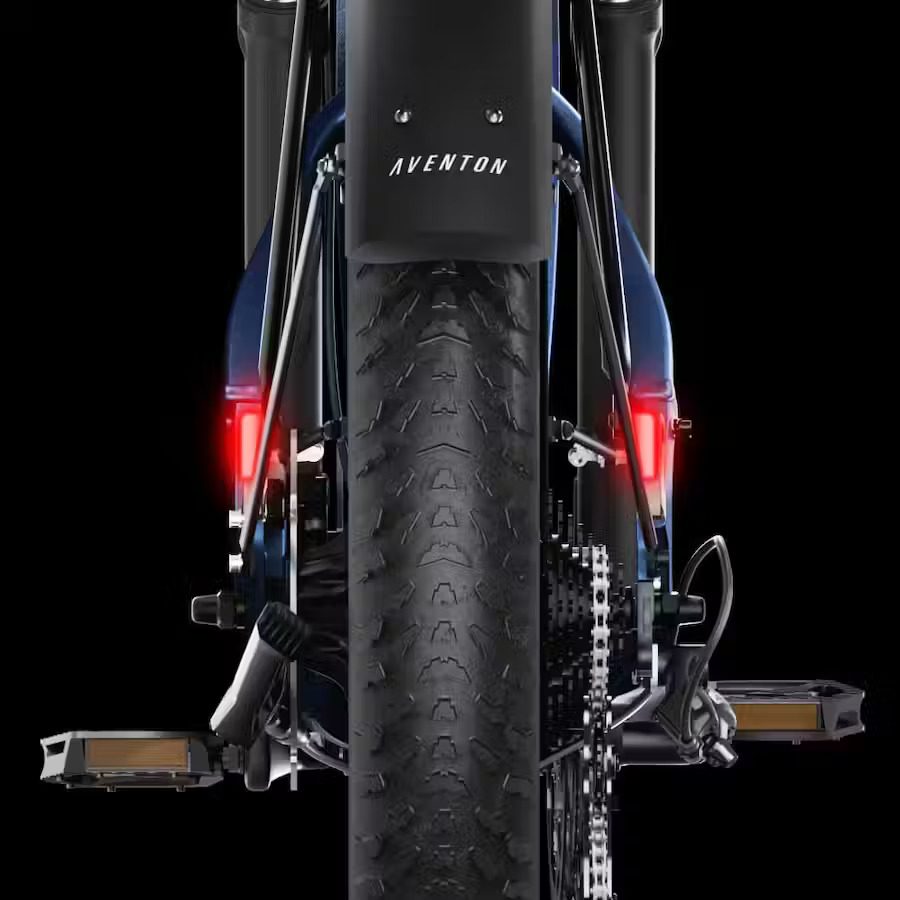 The rear end of an ebike with lights on it.