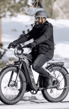 A man riding a fat bike in the snow, equipped with ebikes accessories, in WA, USA.