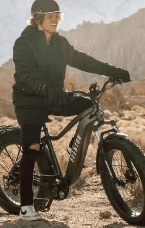 A man riding a fat bike in the desert, with e-bike accessories.