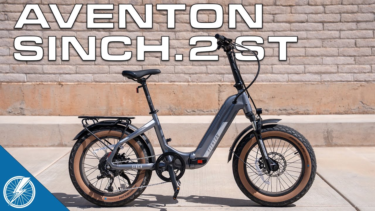 The aventon sinch st electric bike is parked in front of a brick wall in the USA.