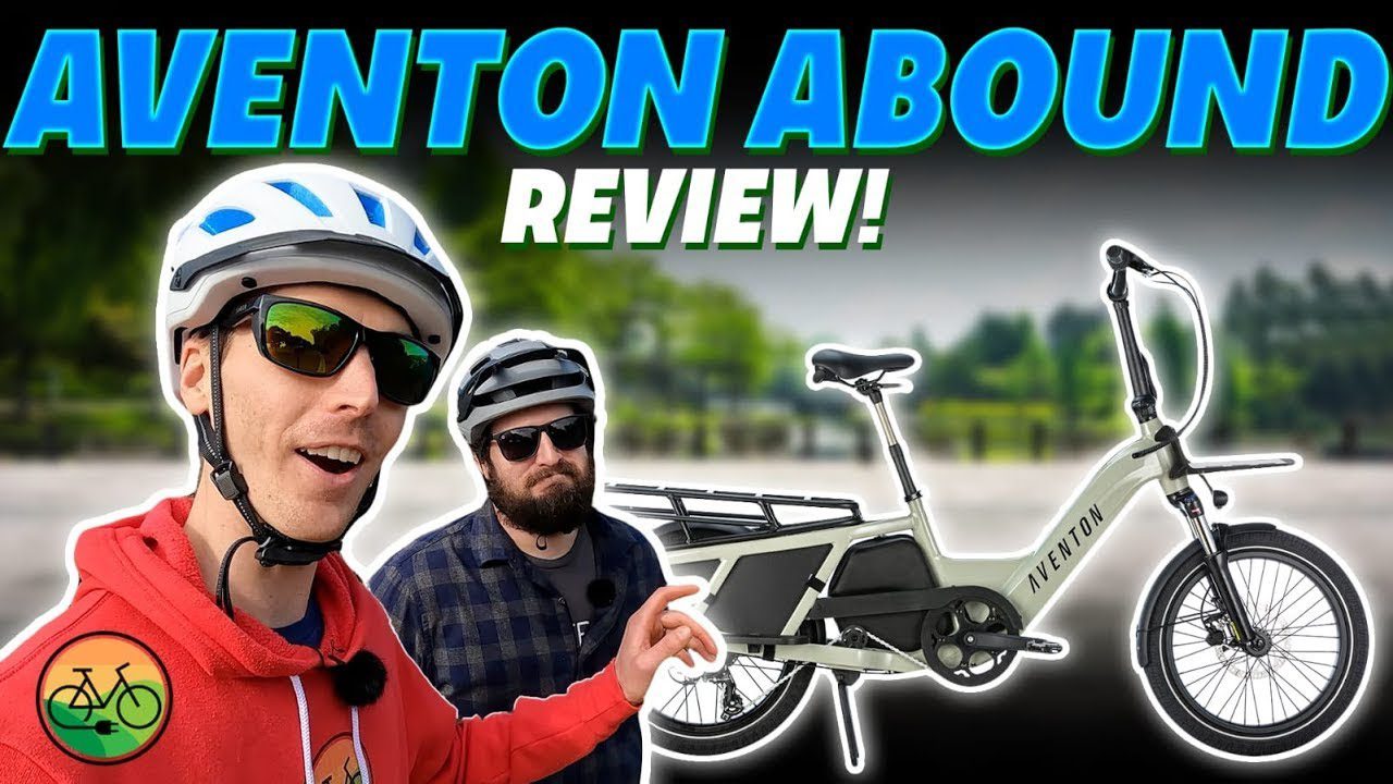 A man and a woman are standing next to an electric bike, discussing their Aventon e-bike review.