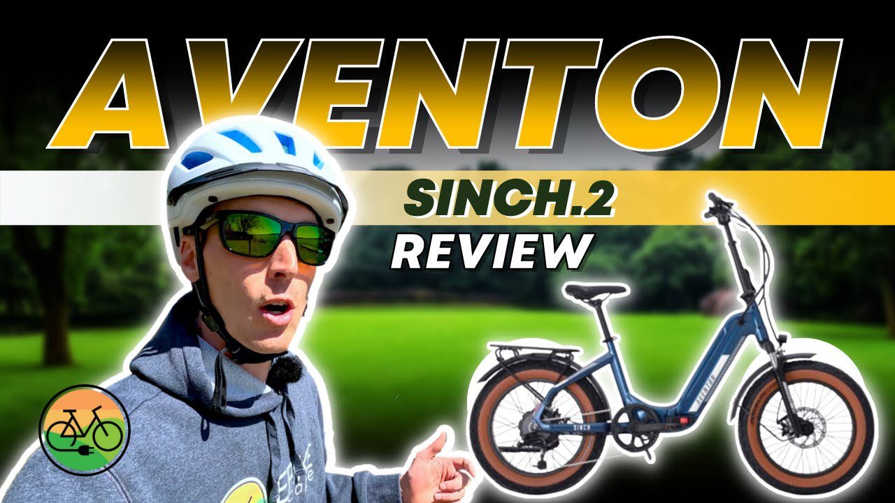 A man wearing a helmet with the words "aventon sinc2 review" examines ebikes and e-bikes accessories in WA, USA.