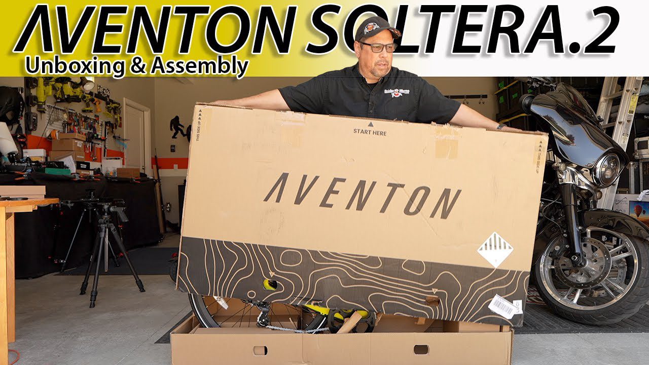 A man standing in front of a box with the words aventon solter 2, showcasing ebikes and e-bikes accessories.