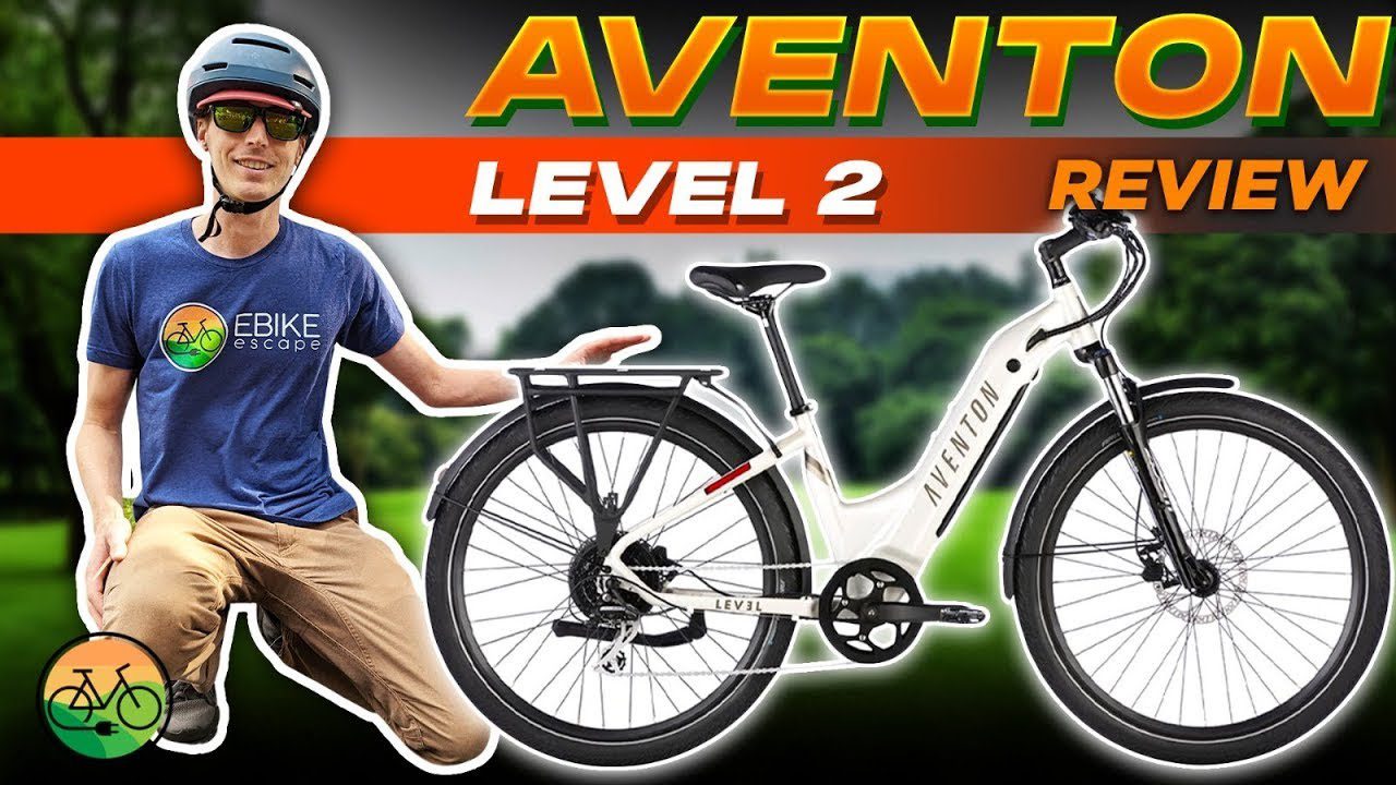 A man is sitting on a USA bike with the words aventon level 2 review.