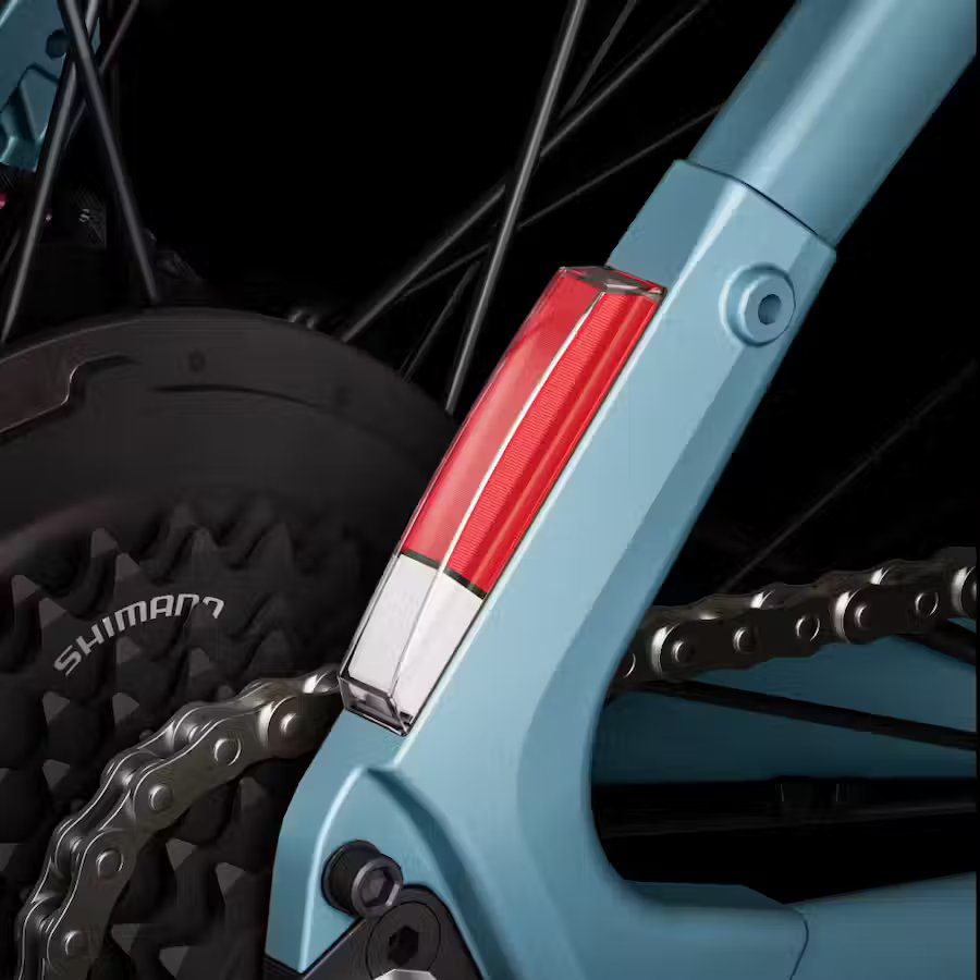 A close up of a blue bicycle with a red chain, showcasing Ebikes accessories.