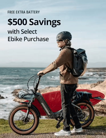 A person stands next to an electric bike by the coast. Text reads: "Free extra battery. $500 savings with select Ebike purchase.