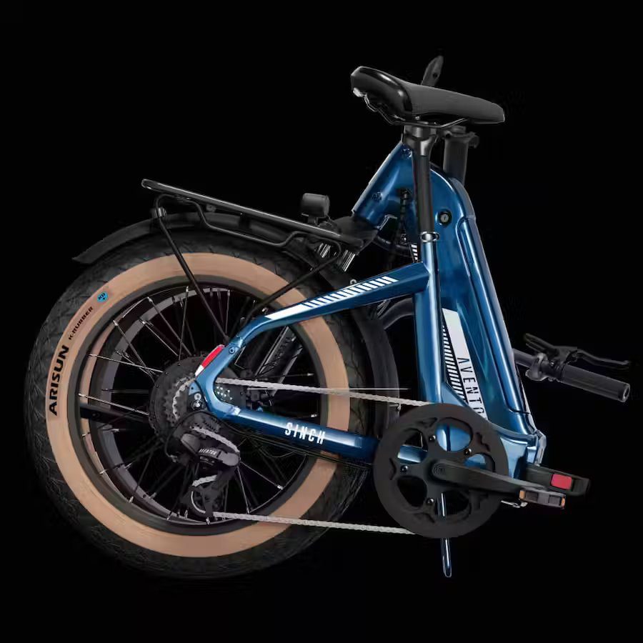 A blue folding bike is shown against a black background.