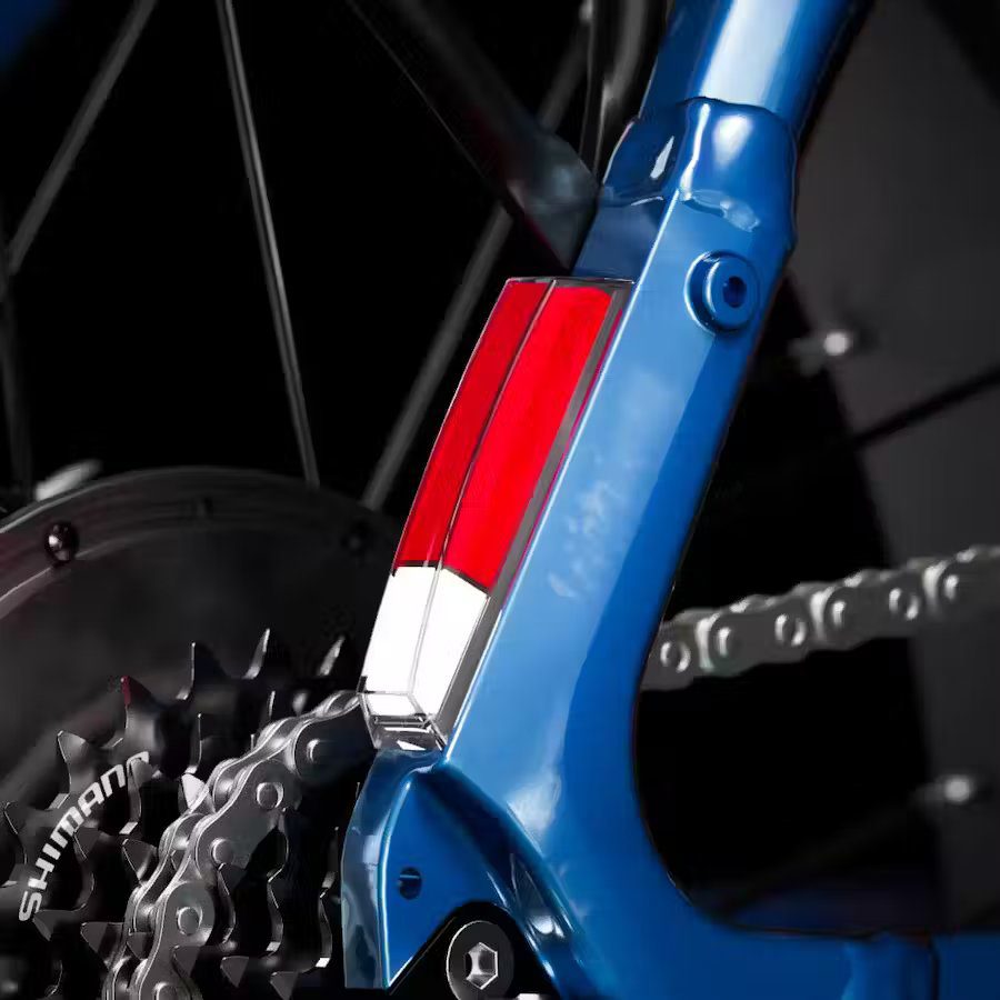 A close up of a blue bicycle with a chain and chainring, suitable for ebikes and e-bikes accessories.