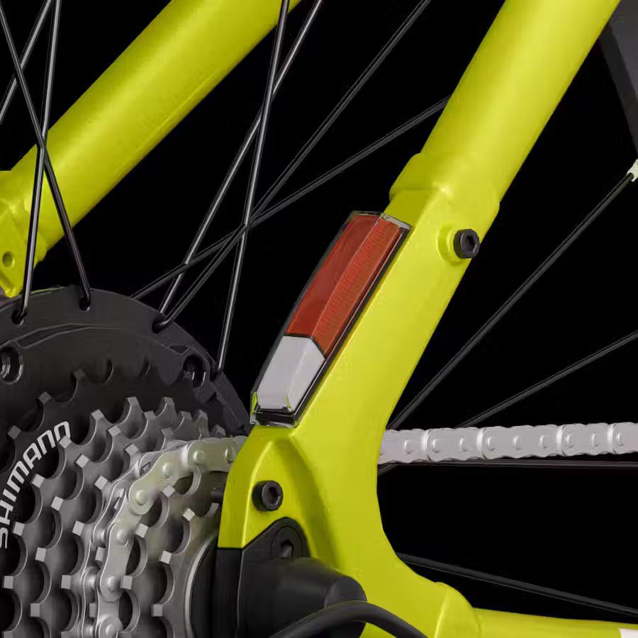 A close up of a yellow bicycle with a gear on it, featuring e-bikes accessories.