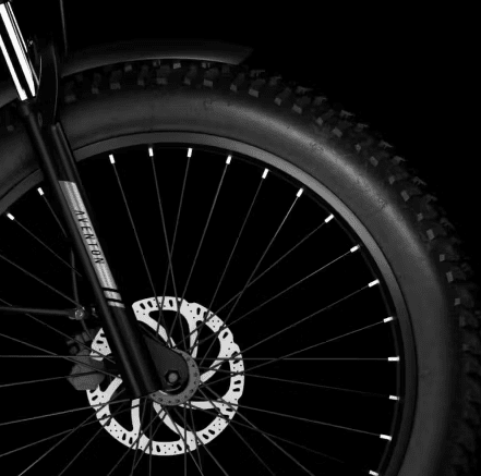 A black and white image of a fat bike with ebikes accessories.