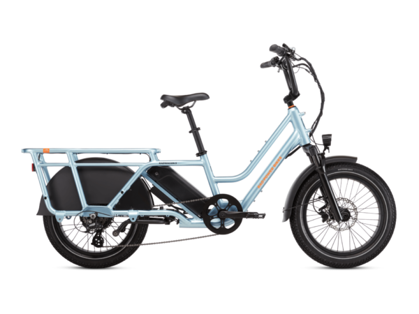 A light blue, electric cargo bike with a step-through frame, black saddle, and integrated rear cargo rack. The bike has front and rear fenders and an electric motor mounted in the rear wheel hub.