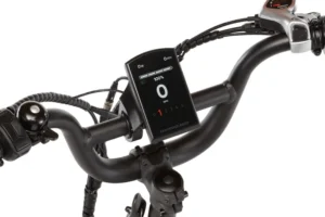 Close-up of an electric bike handlebar featuring a digital display showing speed, battery level, and various control buttons for different settings.