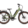 Green electric bicycle with a step-through frame, wide tires, front suspension, rear rack, and handlebar display, shown from the side against a white background.