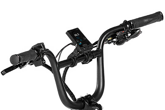 Close-up of bicycle handlebars featuring a digital display, brake levers, and gear shifters.