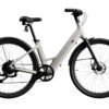 The Carbon 1 Step-Thru is a stylish white electric bicycle featuring a step-through frame, black wheels, and a contemporary design, displayed on a white background.