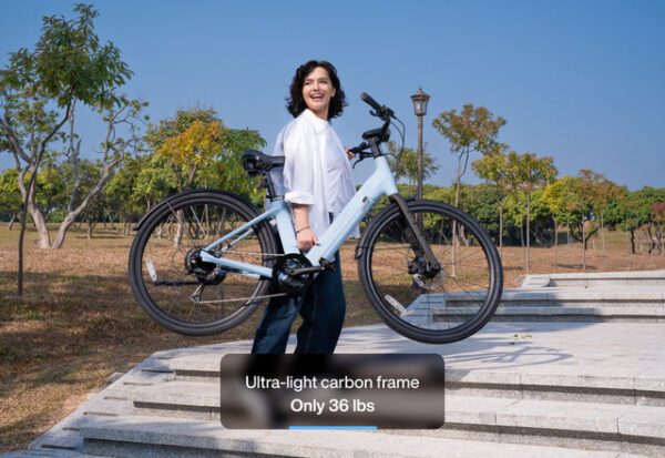 Person carrying a light blue bicycle up stone stairs in a park, with text overlay highlighting "Ultra-light carbon frame, Only 36 lbs.