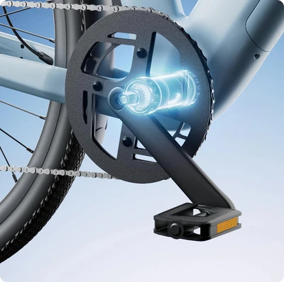 A bicycle crank and chainring are shown, featuring a glowing, transparent graphics overlay of an internal mechanism. The rear wheel and tire are partially visible in the background.