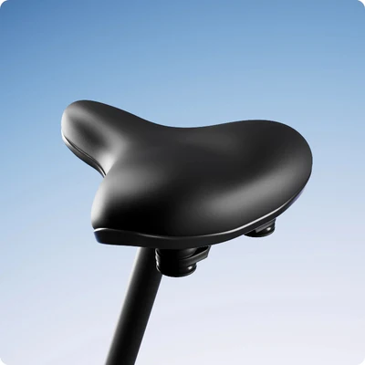 Black bicycle seat on a seat post against a blue gradient background.