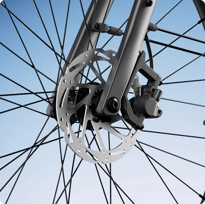 Close-up of a bicycle wheel with a disc brake mechanism against a blue background.