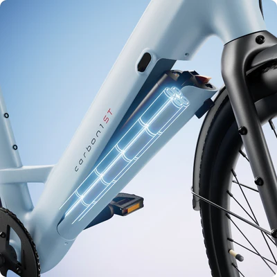 Close-up of a light blue bicycle frame showcasing an illustrated view of the internal battery compartment labeled "carbon1ST.