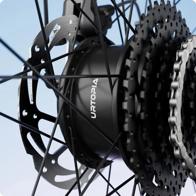 Close-up of a bicycle hub and gear cassette with the brand "URTOPIA" visible, surrounded by spokes and a disc brake, set against a gradient blue background.