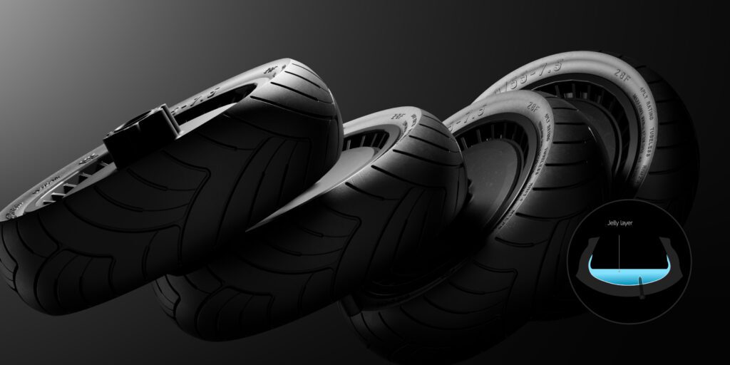 Four black tires are shown in a row against a gradient background, with an inset diagram highlighting a blue jelly layer inside the tire's cross-section.