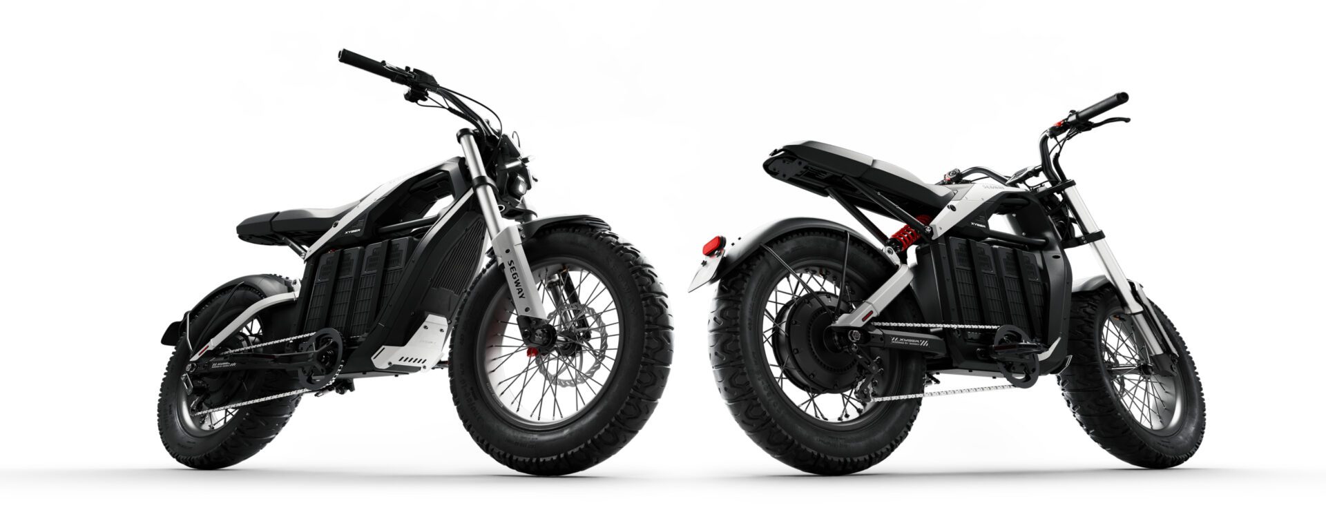 Two black and silver electric motorcycles are shown from side and rear angles, featuring thick tires and minimalist designs against a white background.