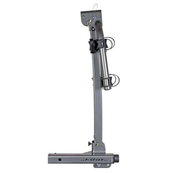 A vertical view of a silver Kuat Beta™ bike rack in a folded position, displaying mounting hardware and securing cables.