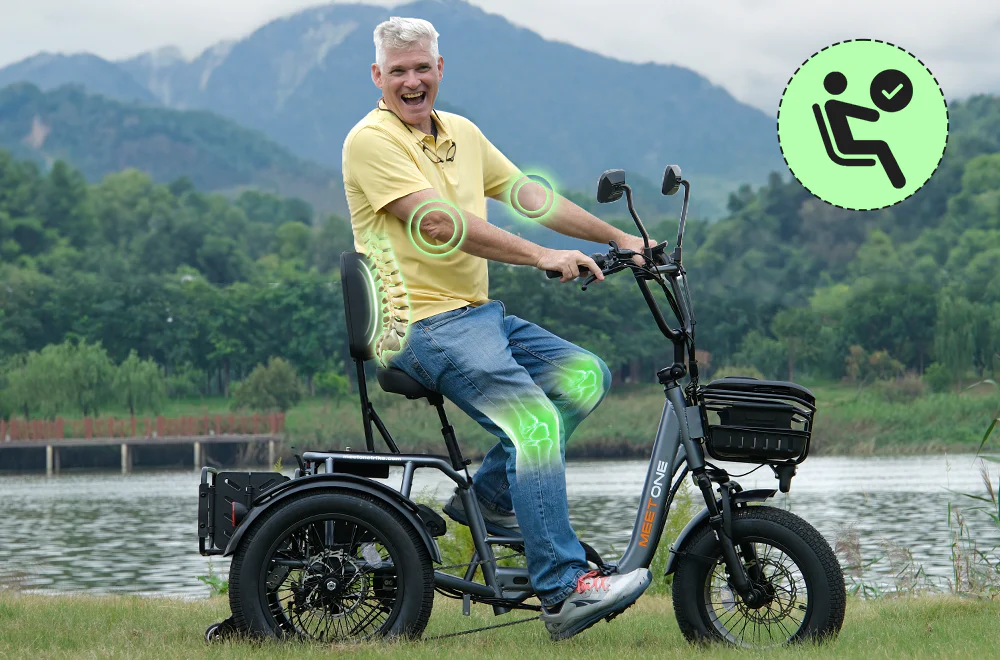 Smiling older man rides a three-wheeled electric bike by a lake, with green graphics highlighting his joints and a symbol indicating seating comfort.