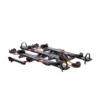 The NV™ 2.0 Add-On is a black and orange platform-style bike rack featuring wheel trays and securing straps, designed to hold multiple bicycles.