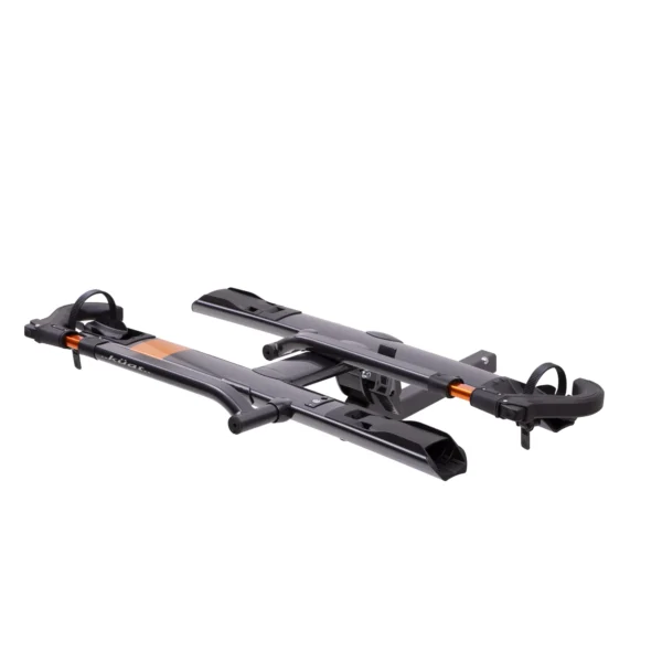 The Sherpa™ 2.0 is a black and orange platform-style hitch bike rack with two wheel trays and adjustable arm supports, shown on a white background.
