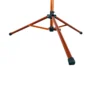 A close-up view of the orange metal base and legs of the Tri Doc - Trail Doc Stand tripod, featuring black rubber feet, isolated on a white background.
