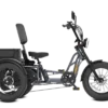 The Meet One Tour Lite Full Suspension Electric Trike is a three-wheeled electric bike featuring a large cushioned seat, wide tires, rear cargo box, and upright handlebars, shown in a side view.